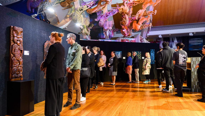People looking at the artworks in the Ringa Toi exhibition.