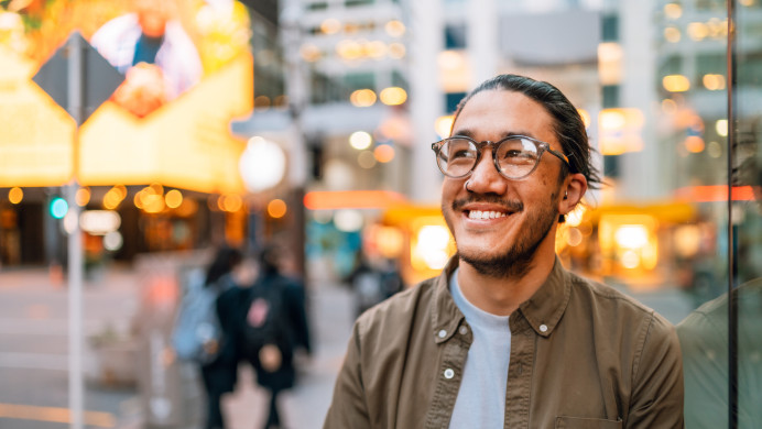 Smiling young man in a city setting