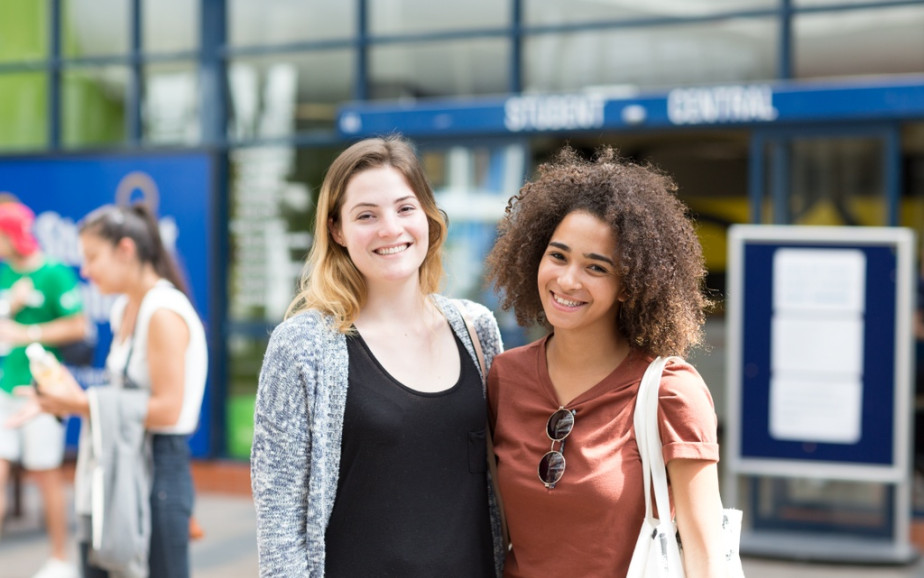 Two international students smile