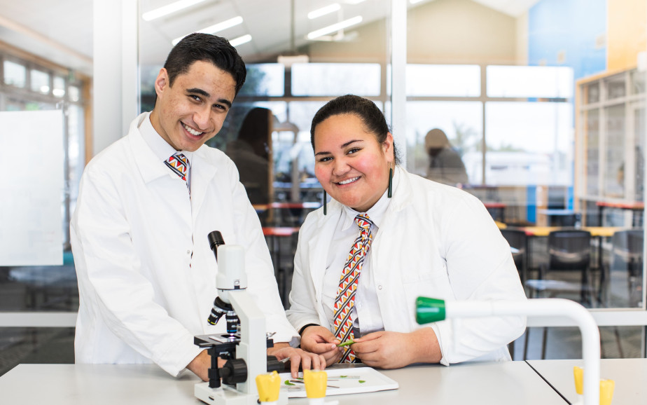 Two people in laboratory with microscope