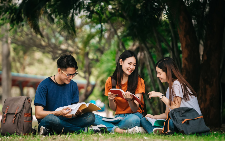 Three people studying outside