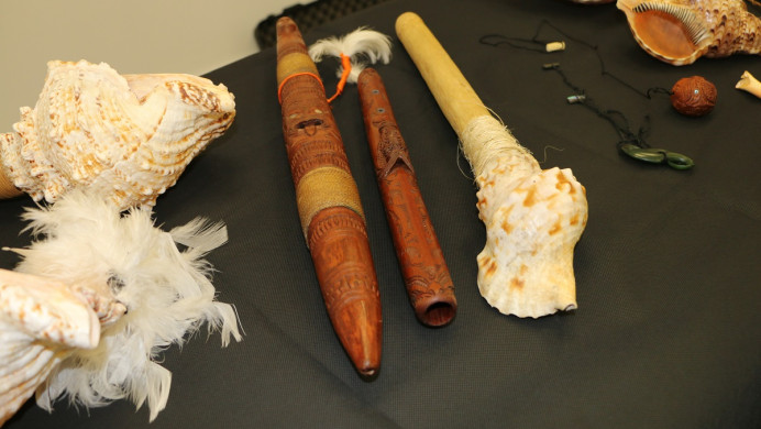 A collection of puoro, including conch and wood flutes