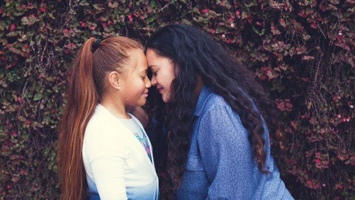 A woman and girl do a hongi