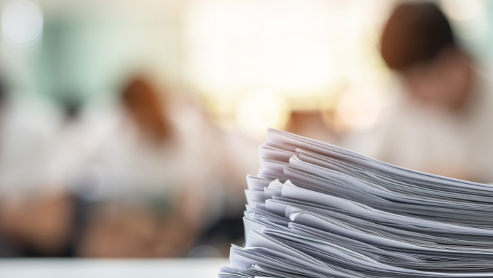 Stack of exam papers on a desk