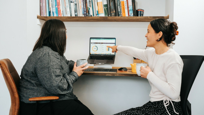two women looking at a laptop