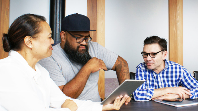 Three New Zealanders of different ethnicity are in a casual business meeting. 