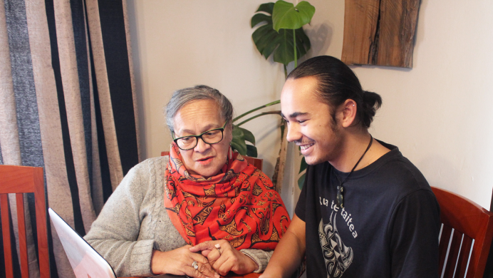 Grandmother and grandson search on laptop