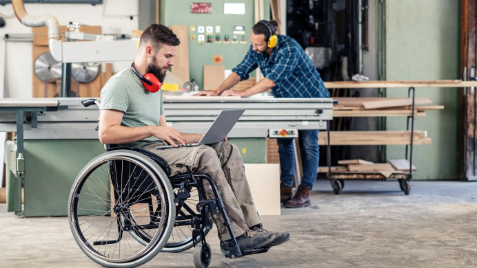 Two men in carpentry workshop